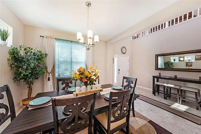 a view of a dining room with furniture and chandelier