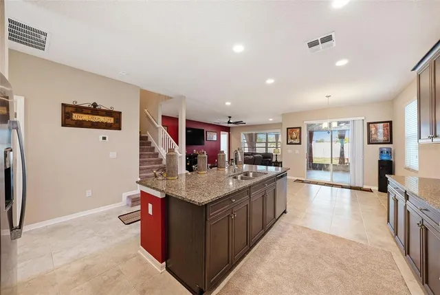 a kitchen with stainless steel appliances granite countertop a stove and a refrigerator