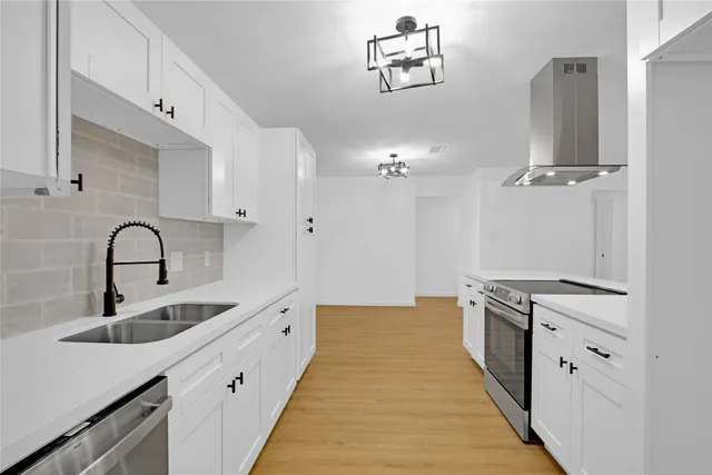 a kitchen with granite countertop a sink and cabinets