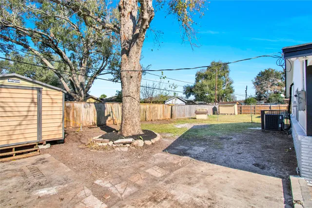 a view of a backyard with large trees