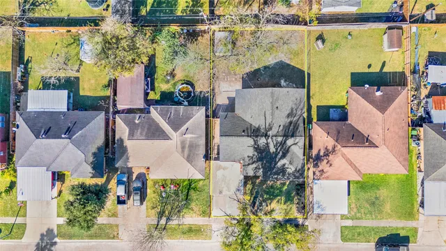 an aerial view of a house with a garden and trees