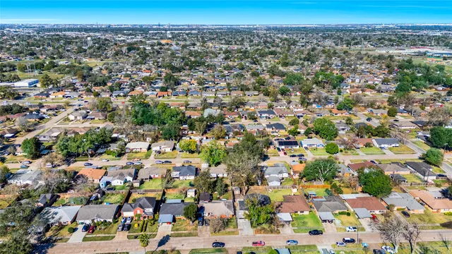 an aerial view of a residential houses with city view