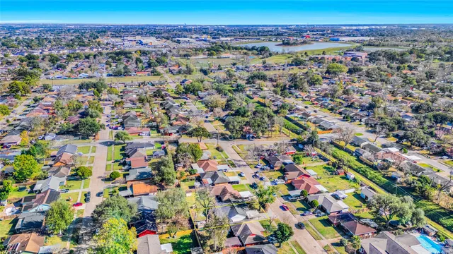 an aerial view of a house with a yard and swimming pool