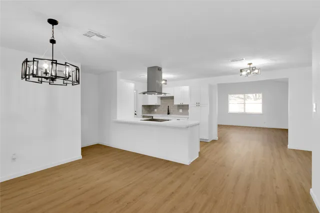 a view of a kitchen with sink and microwave