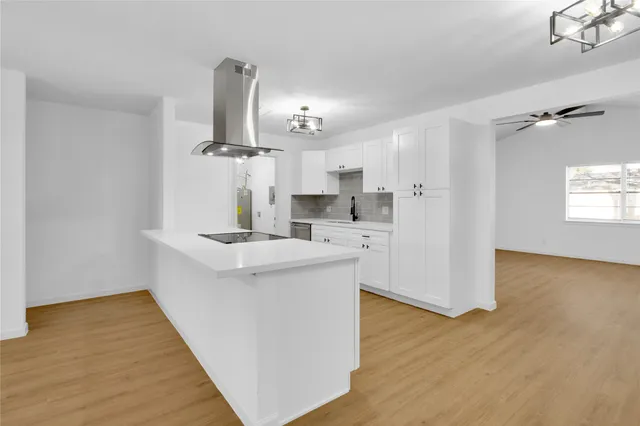 a kitchen with stainless steel appliances a sink and a refrigerator