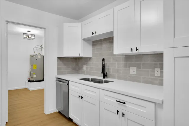 a kitchen with a sink and cabinets