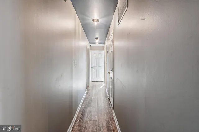 a view of a room with wooden floor and a window