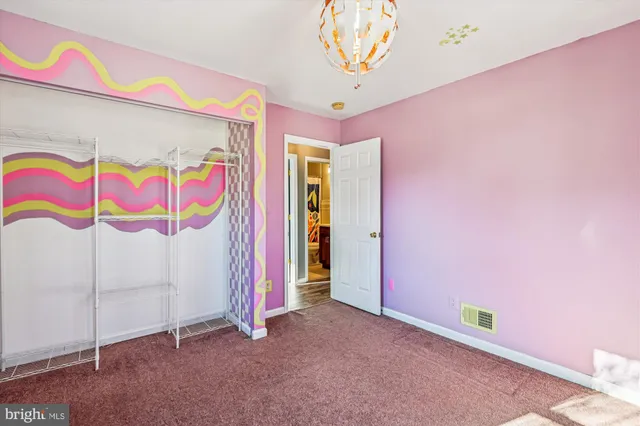 front view of a house with a yard and potted plants