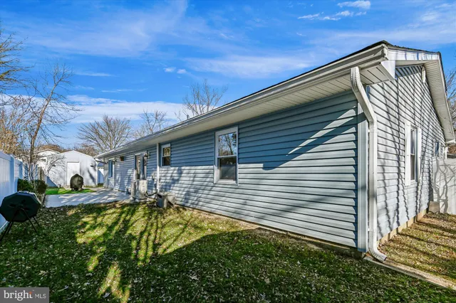 a view of a house with a door and wooden bench