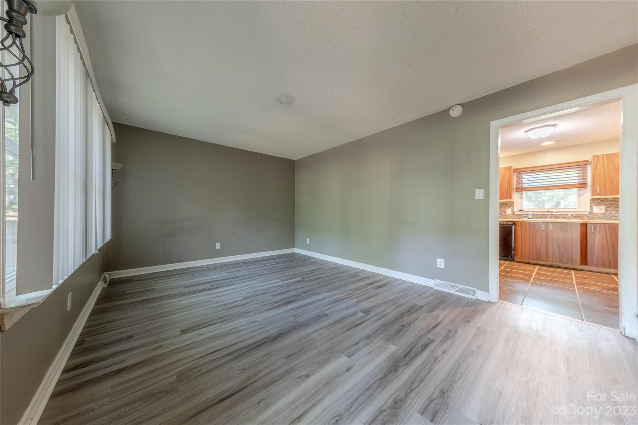 1702 Carson Street Monroe, NC 28110 - Photo 3 of 29 wooden floor in an empty room with a window
