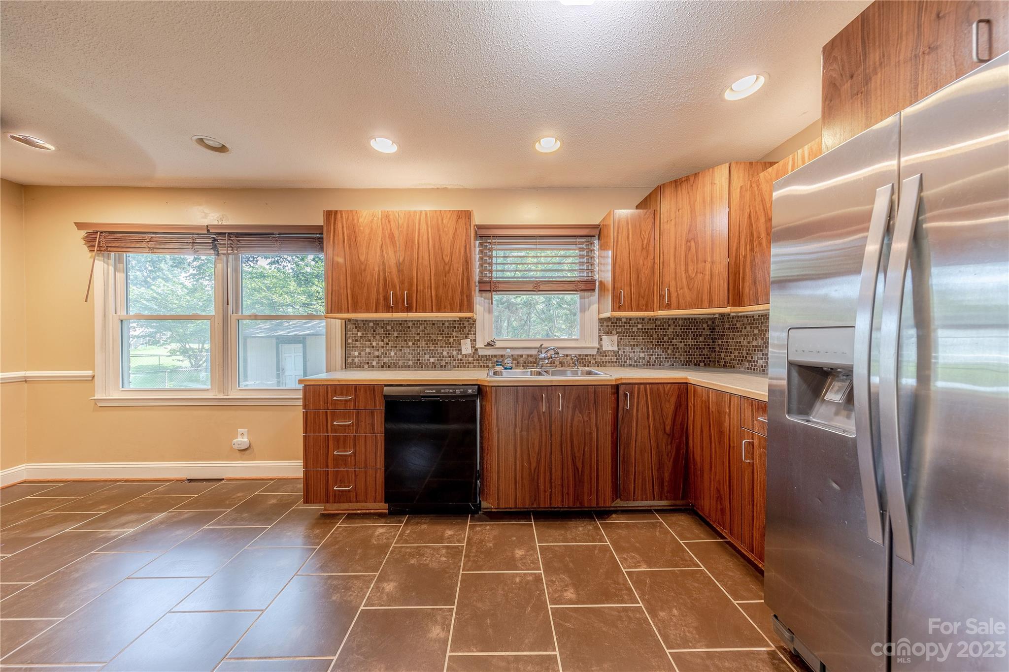 1702 Carson Street Monroe, NC 28110 - Photo 5 of 29 a kitchen with stainless steel appliances granite countertop a refrigerator and a sink