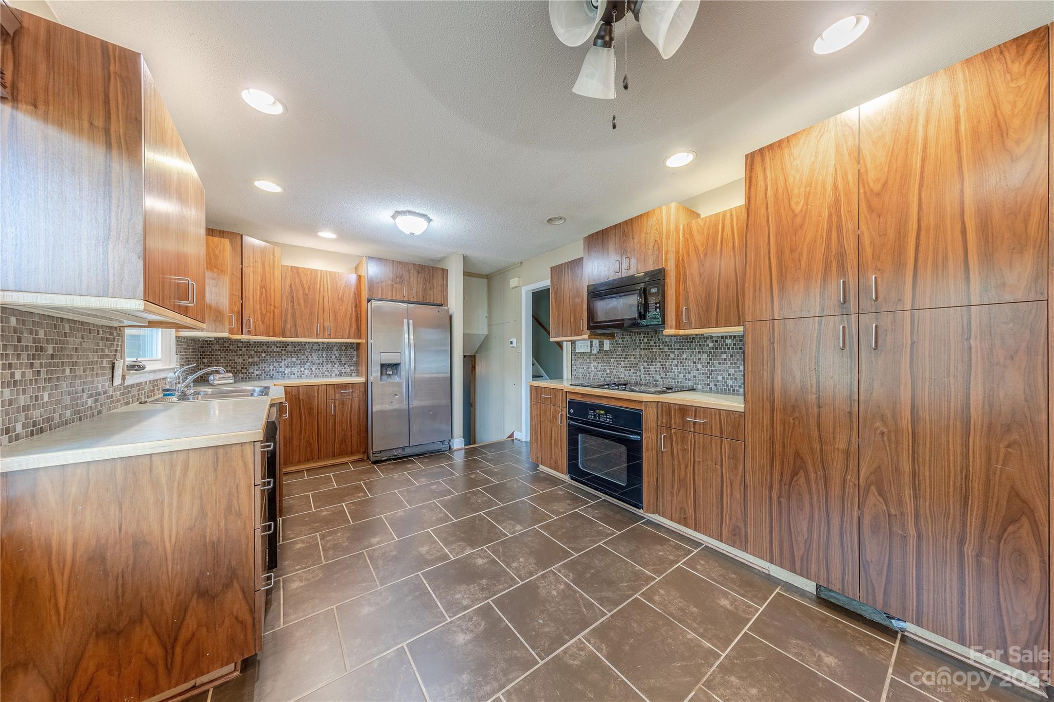 1702 Carson Street Monroe, NC 28110 - Photo 6 of 29 a large kitchen with stainless steel appliances granite countertop a stove a sink and a microwave