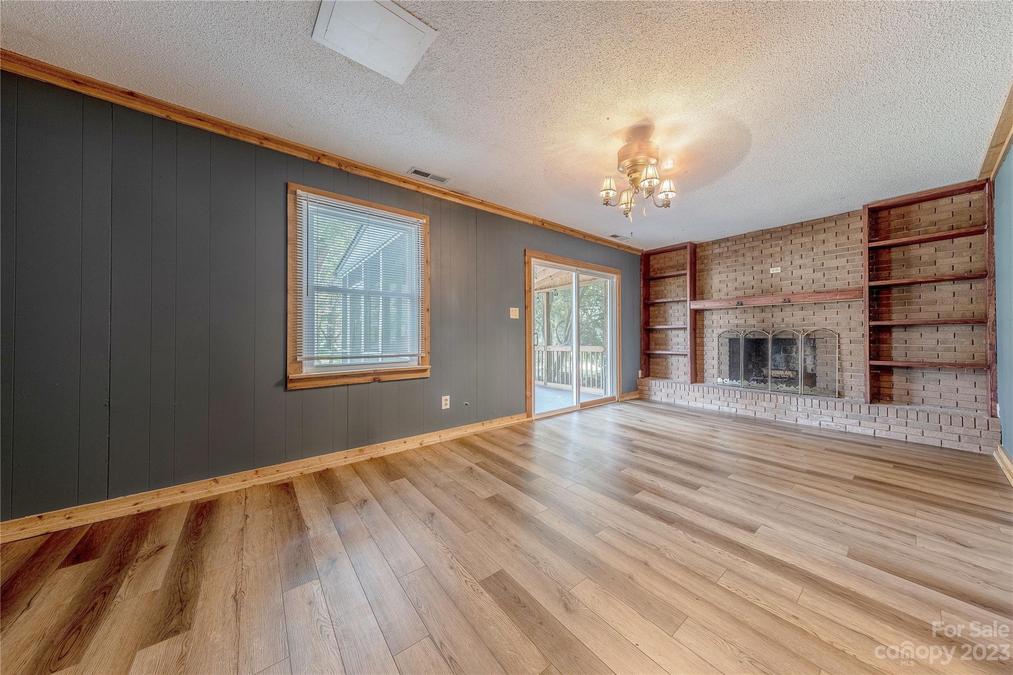 1702 Carson Street Monroe, NC 28110 - Photo 9 of 29 a view of an empty room with wooden floor fireplace and a window