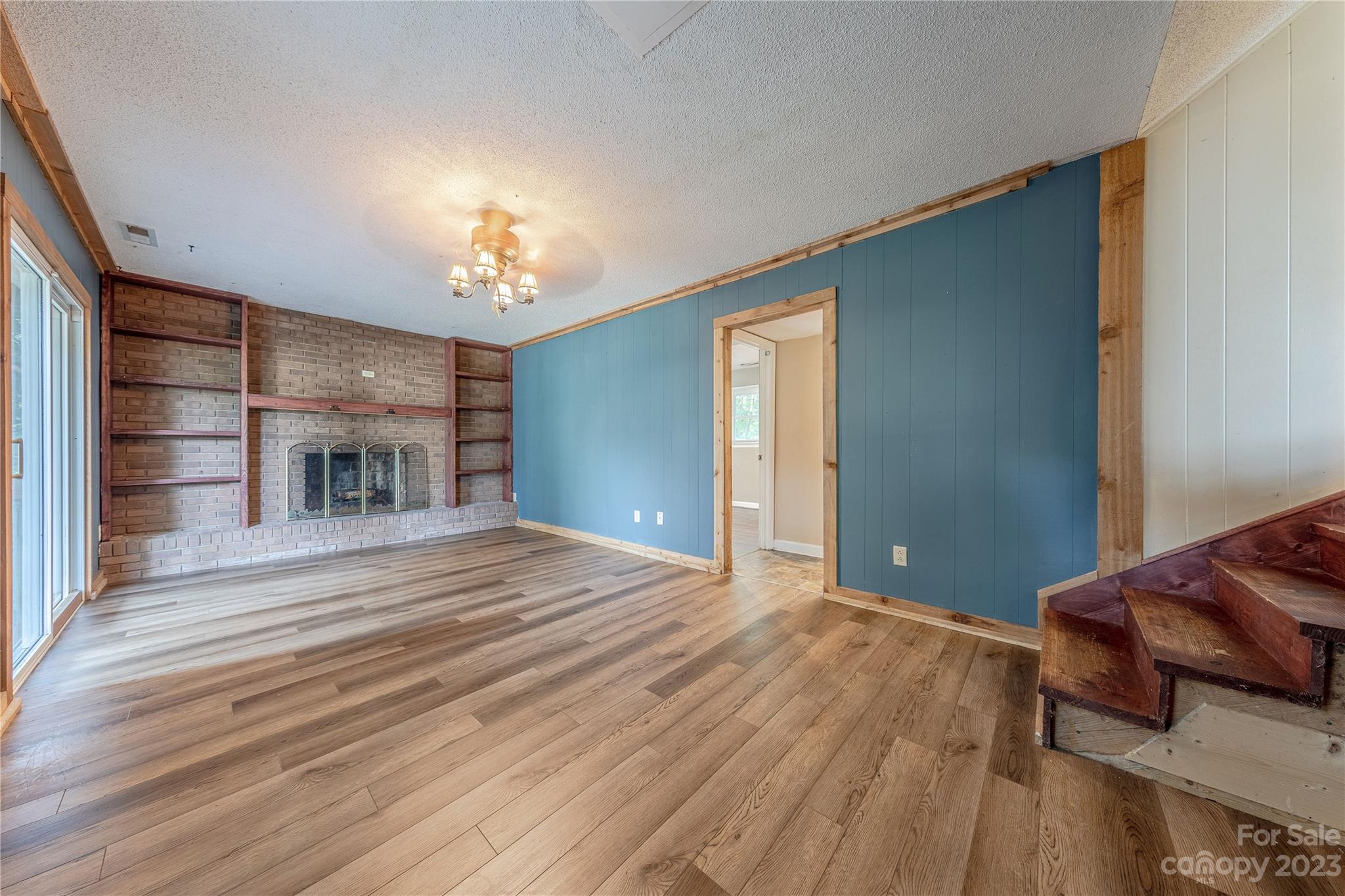 1702 Carson Street Monroe, NC 28110 - Photo 10 of 29 a bedroom with a bed and a chandelier