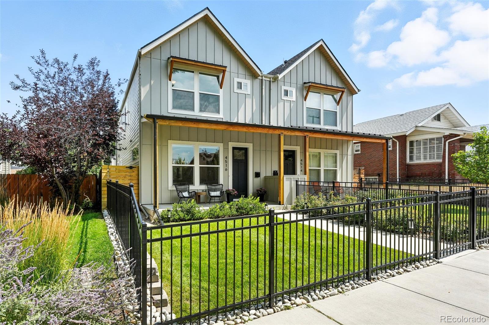 4516 Stuart Street Denver, CO 80212 - Photo 1 of 46 a front view of a house with a garden and plants