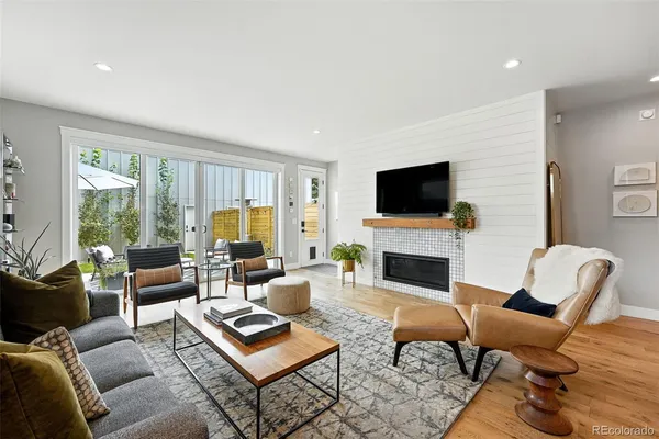 a living room with furniture a fireplace and a flat screen tv