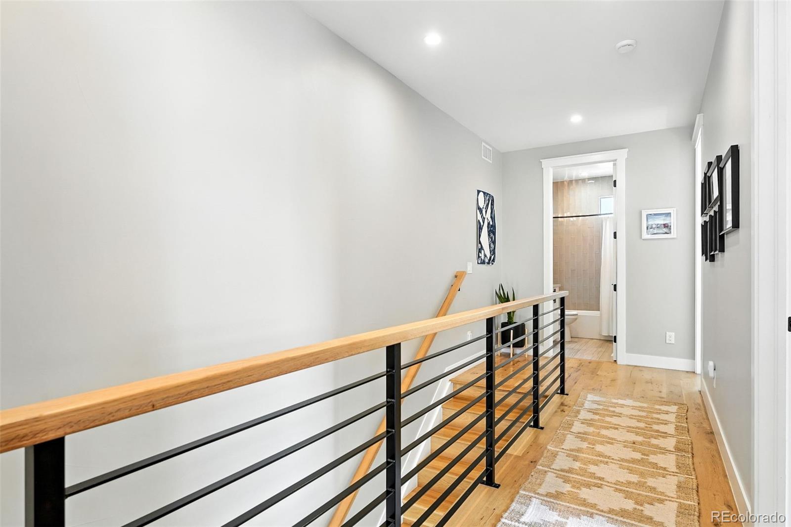 4516 Stuart Street Denver, CO 80212 - Photo 19 of 46 a hallway with wooden floor