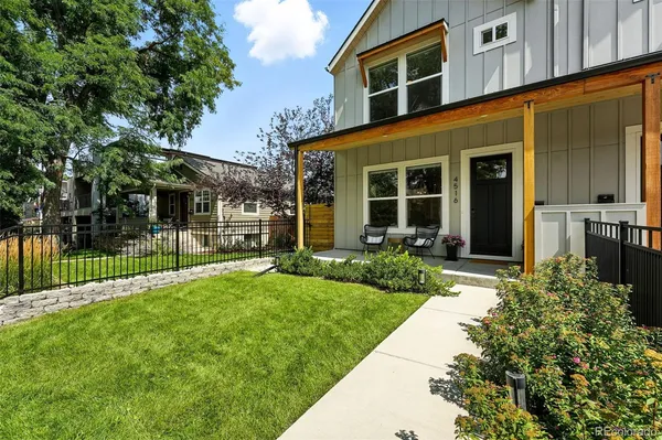 a view of a house with backyard and porch