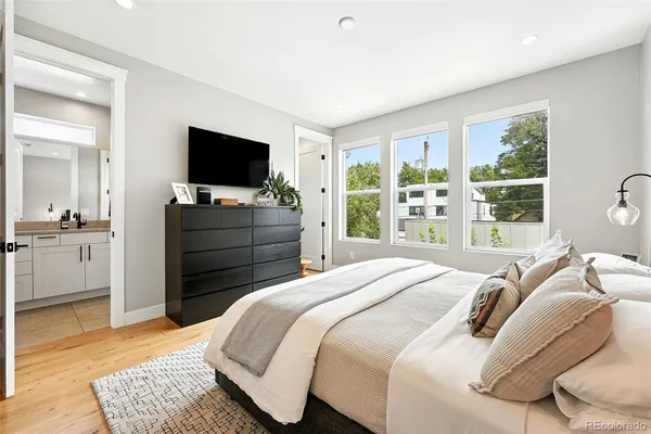 a bedroom with a bed and a flat screen television