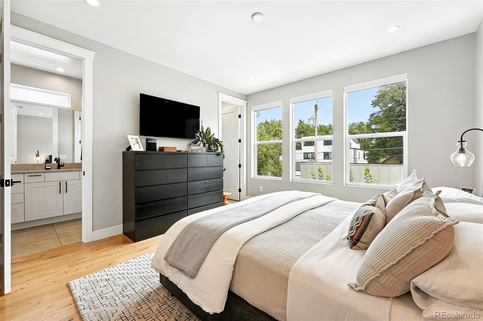4516 Stuart Street Denver, CO 80212 - Photo 23 of 46 a bedroom with a bed and a flat screen television