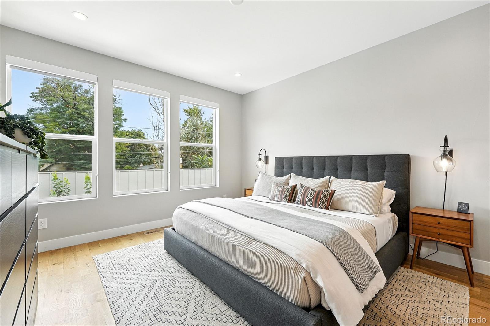 4516 Stuart Street Denver, CO 80212 - Photo 24 of 46 a bedroom with a bed and wooden floor