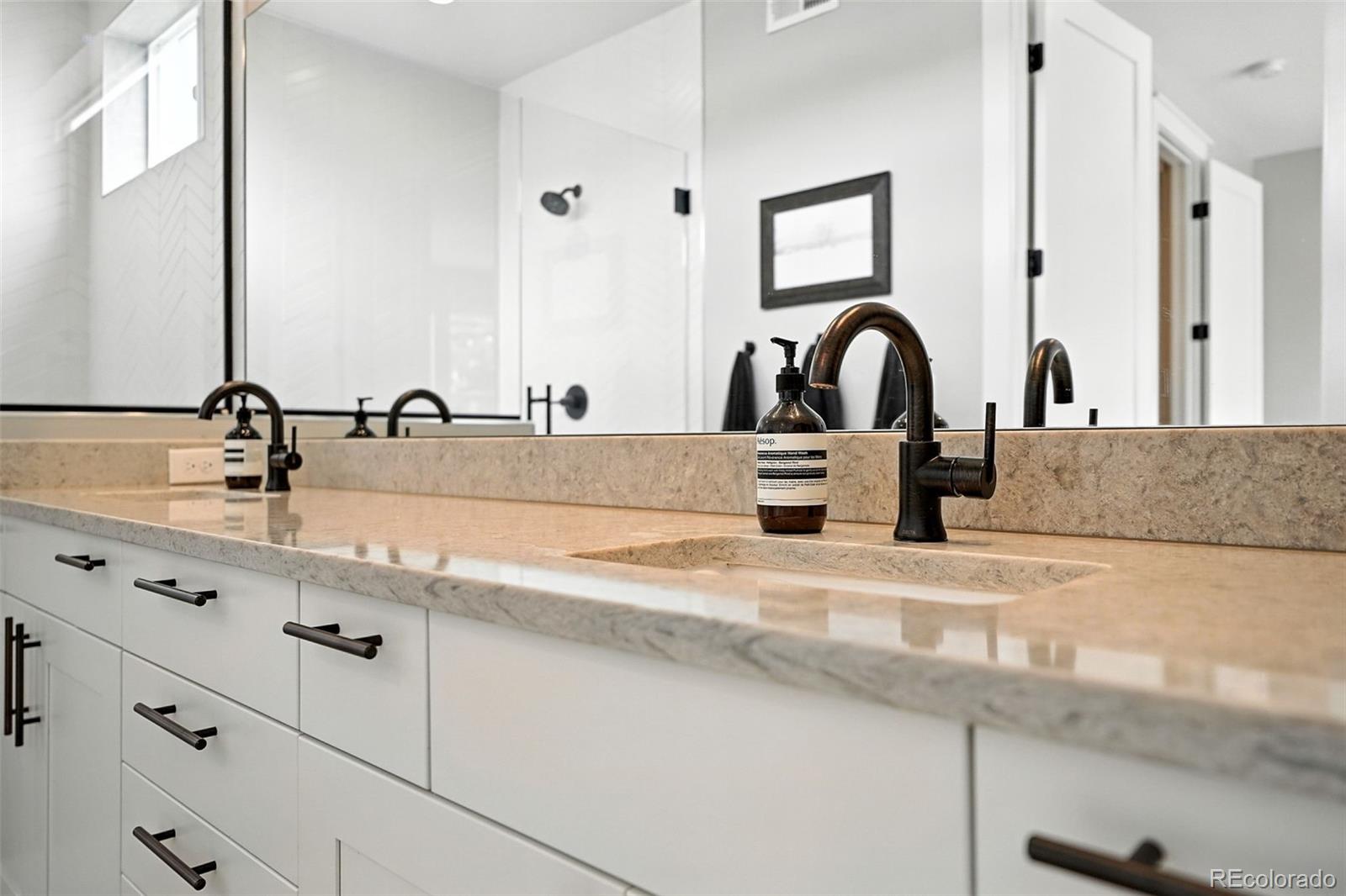 4516 Stuart Street Denver, CO 80212 - Photo 28 of 46 a bathroom with sink and mirror