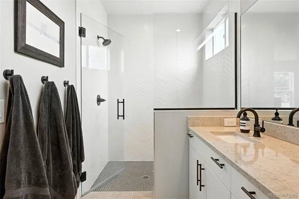 a bathroom with a double vanity sink and a mirror