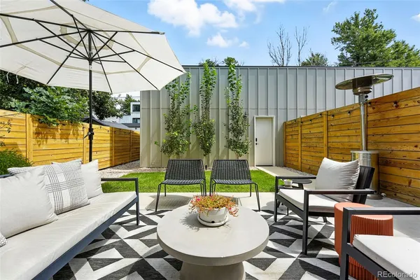 a patio with a table and chairs