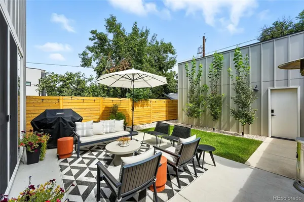 a view of a patio with furniture and a yard