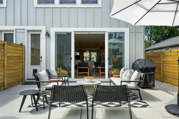 a view of a patio with table and chairs and potted plants