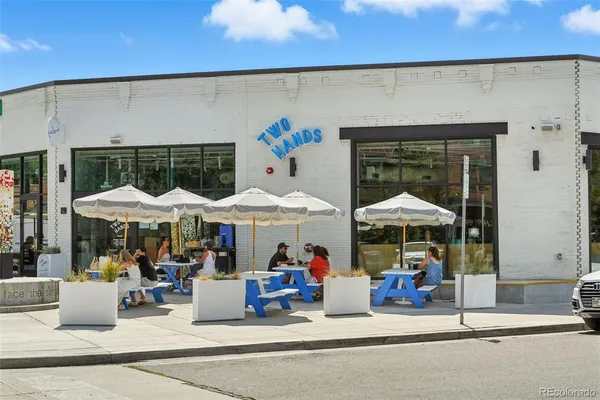 a view of people sitting under an umbrella