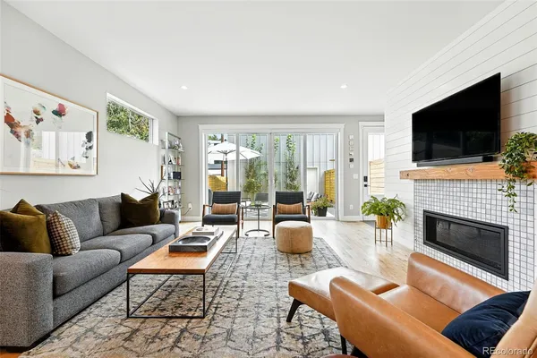 a living room with furniture a fireplace and a flat screen tv