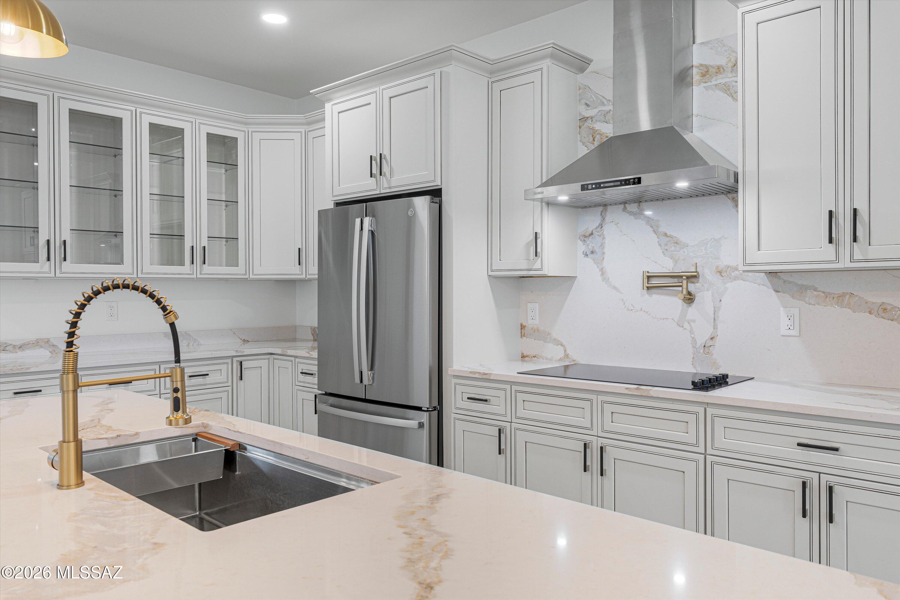 5259 East Fort Lowell Road Tucson, AZ 85712 - Photo 13 of 50 a kitchen with stainless steel appliances a sink a refrigerator and cabinets