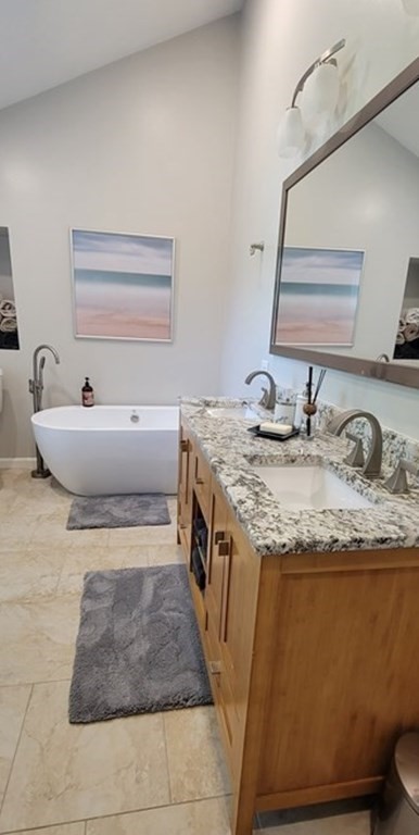 22 Ledgewood Road Wakefield, MA 01880 - Photo 19 of 34 a spacious bathroom with a granite countertop sink and a mirror