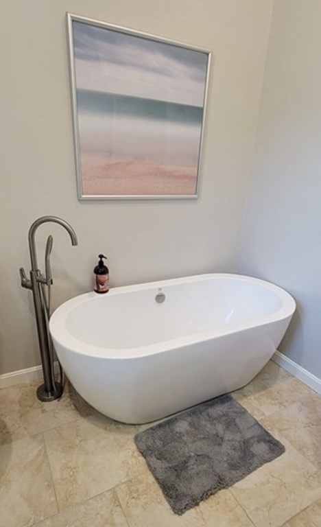 22 Ledgewood Road Wakefield, MA 01880 - Photo 22 of 34 a white bath tub sitting in a bathroom