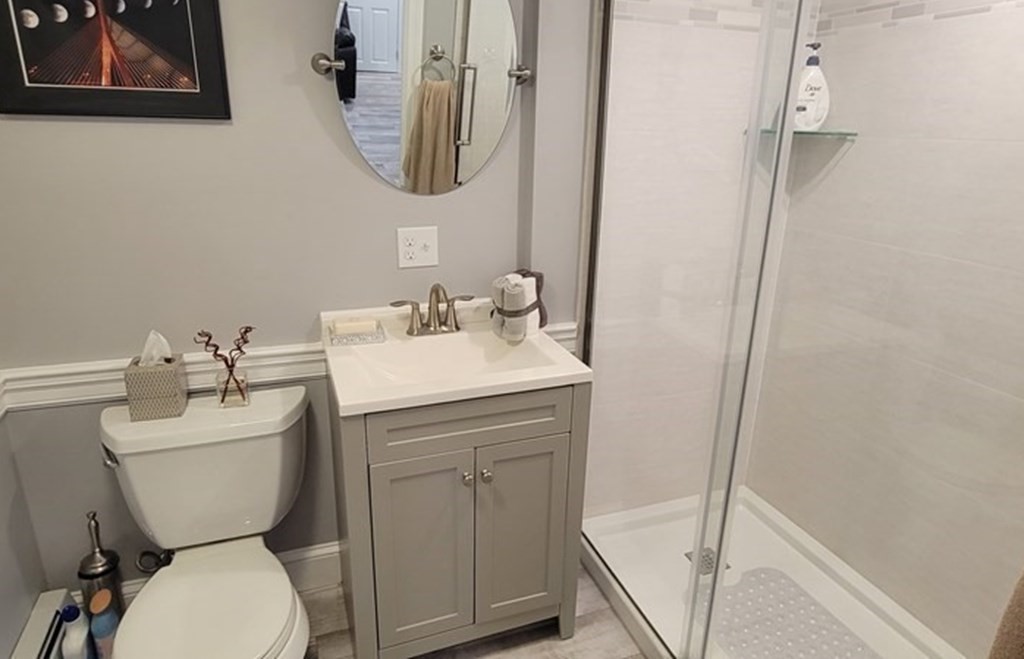 22 Ledgewood Road Wakefield, MA 01880 - Photo 28 of 34 a bathroom with a toilet sink and mirror