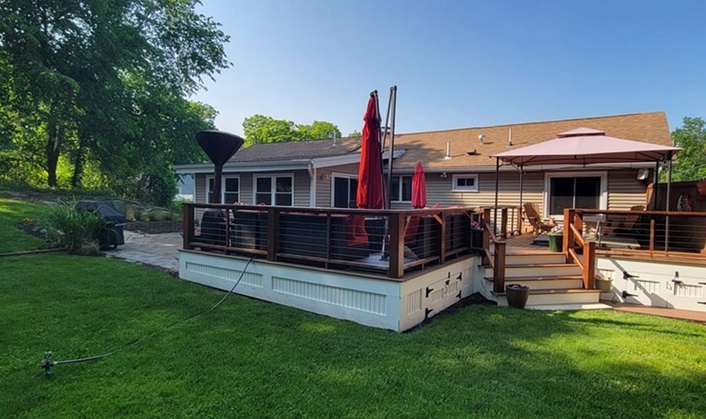 22 Ledgewood Road Wakefield, MA 01880 - Photo 31 of 34 a view of a house with wooden deck and a yard
