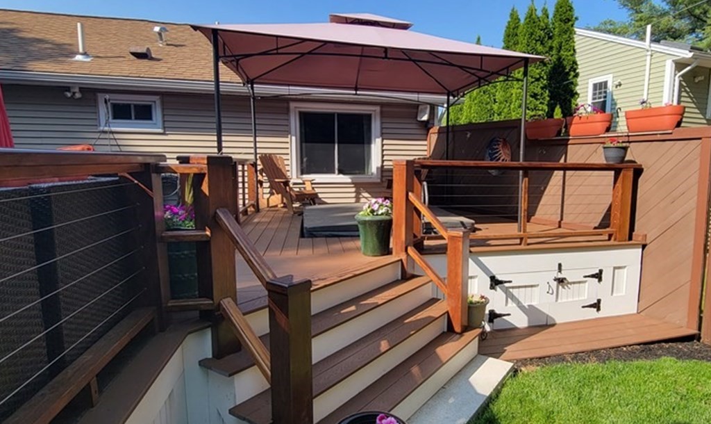22 Ledgewood Road Wakefield, MA 01880 - Photo 32 of 34 a view of a patio with table and chairs under an umbrella