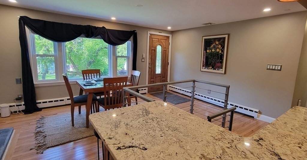 22 Ledgewood Road Wakefield, MA 01880 - Photo 8 of 34 a living room with furniture tv and large windows