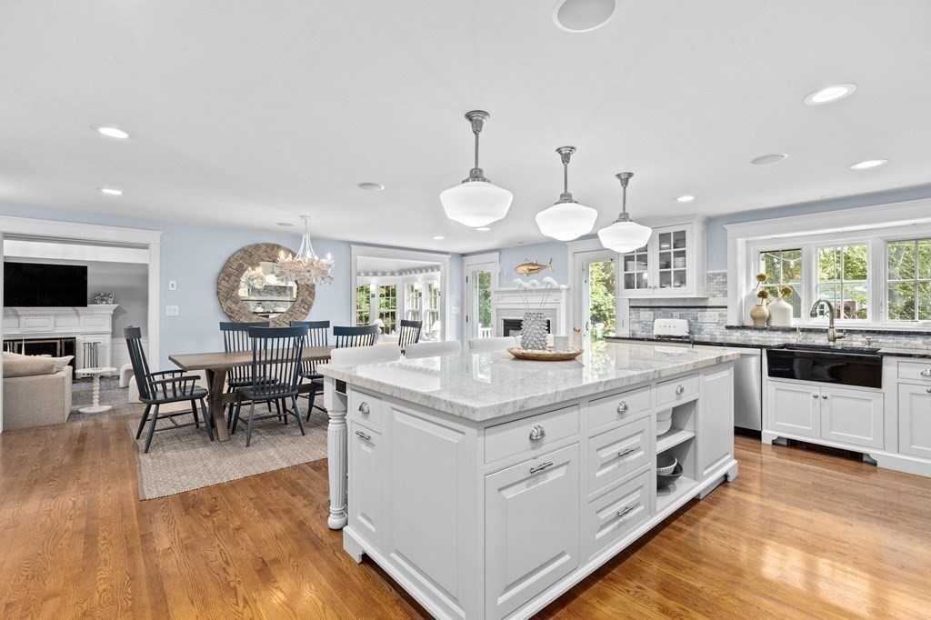 19 Del Prete Drive Hingham, MA 02043 - Photo 8 of 28 a large kitchen with stainless steel appliances a lot of white cabinets a dining table and chairs