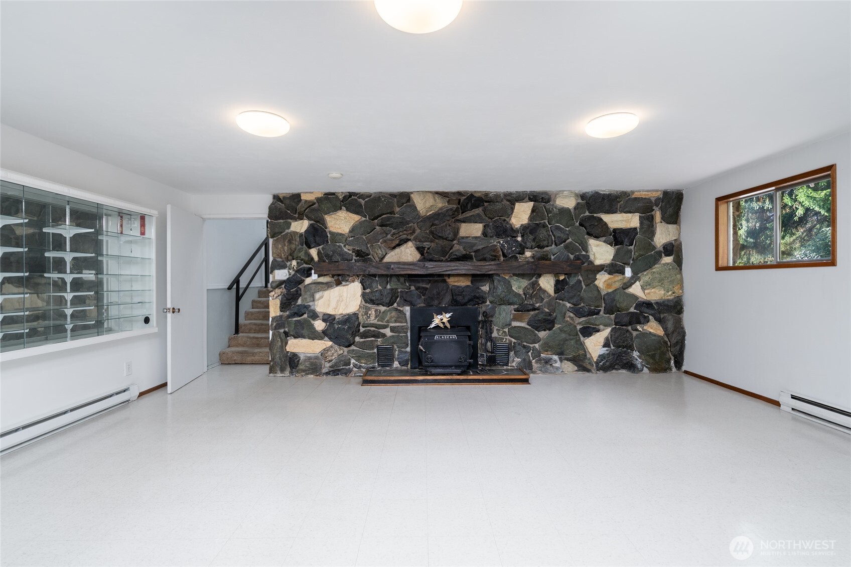 22491 Grip Road Sedro-Woolley, WA 98284 - Photo 11 of 40 a view of an empty room with wooden floor and furniture