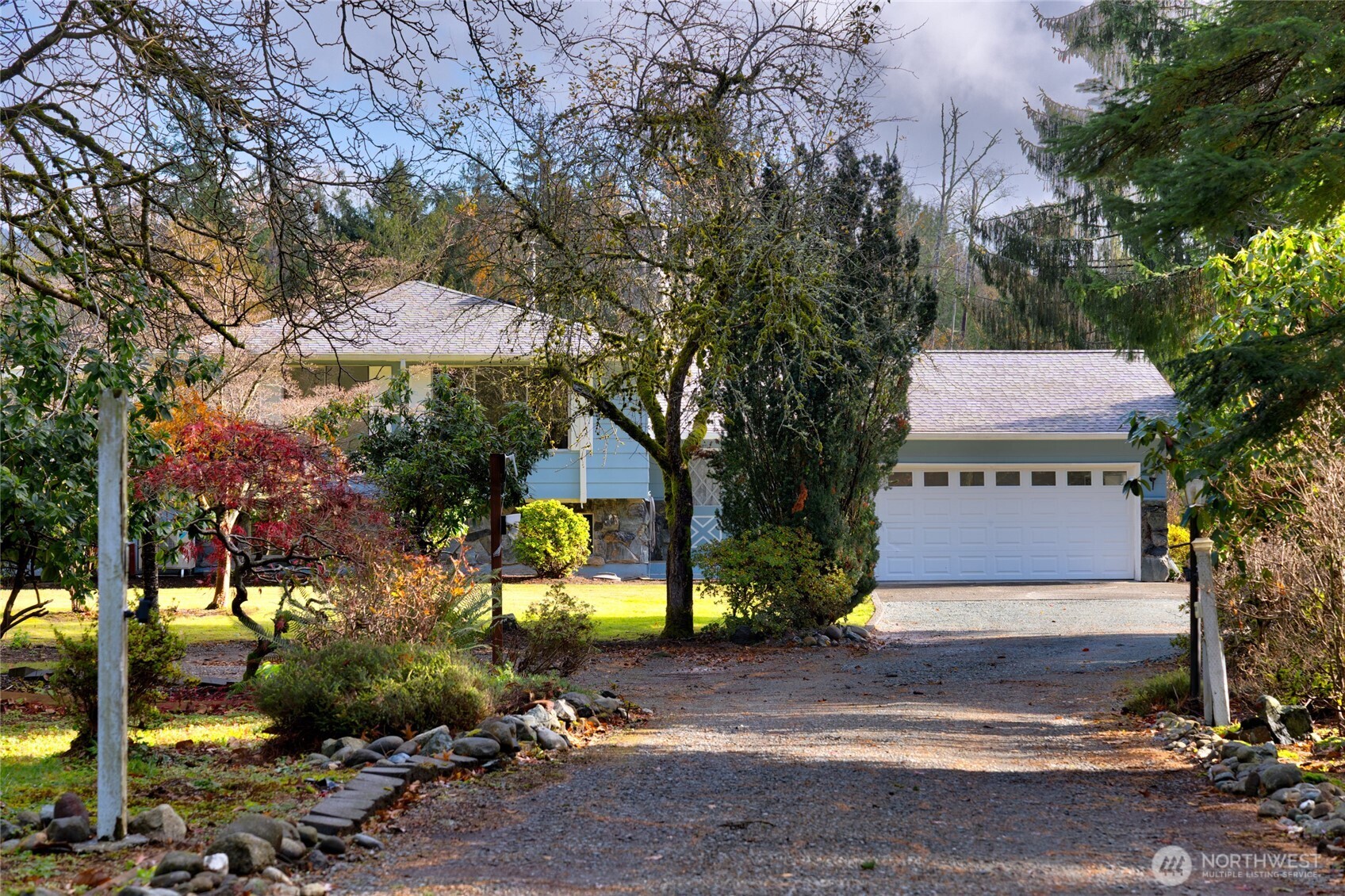 22491 Grip Road Sedro-Woolley, WA 98284 - Photo 2 of 40 a front view of a house with a yard and tree s