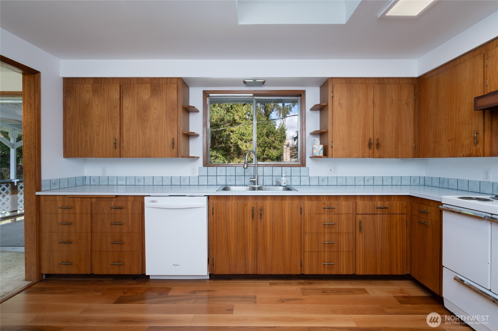 22491 Grip Road Sedro-Woolley, WA 98284 - Photo 22 of 40 a kitchen with stainless steel appliances granite countertop wooden floor a sink and a large window