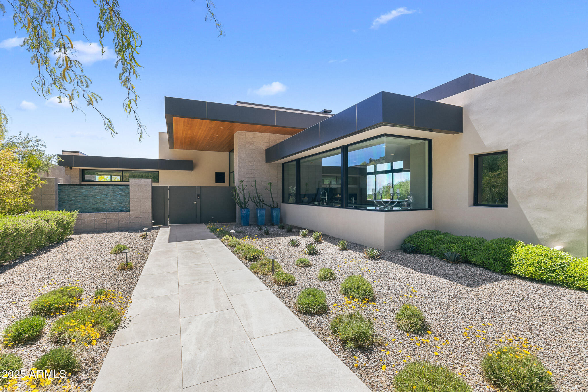 6149 East Indian Bend Road Paradise Valley, AZ 85253 - Photo 6 of 77 a front view of a house with a garden