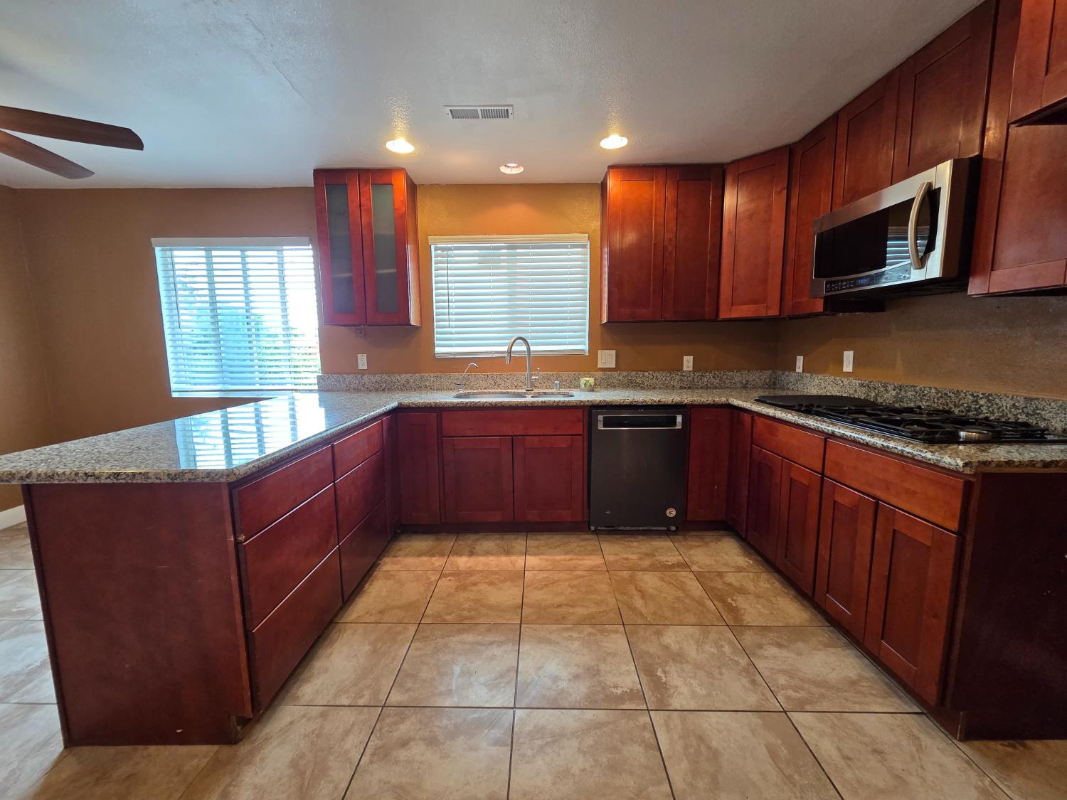 5010 Powerline Road, Unit D Olivehurst, CA 95961 - Photo 5 of 12 a large kitchen with stainless steel appliances granite countertop a sink and cabinets