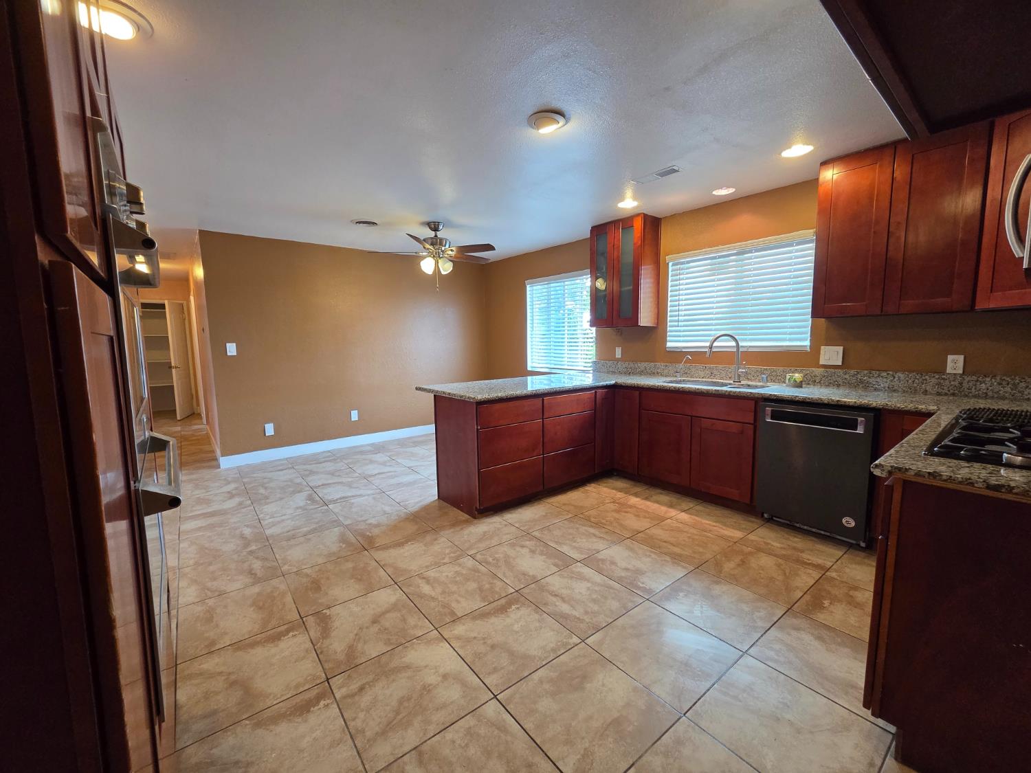 5010 Powerline Road, Unit D Olivehurst, CA 95961 - Photo 6 of 12 a kitchen with stainless steel appliances granite countertop a sink stove and refrigerator