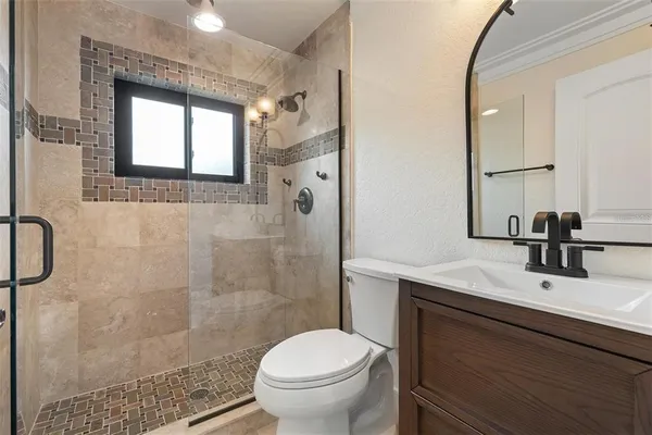 a bathroom with a sink toilet and shower
