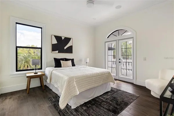 a bedroom with a large bed and a window