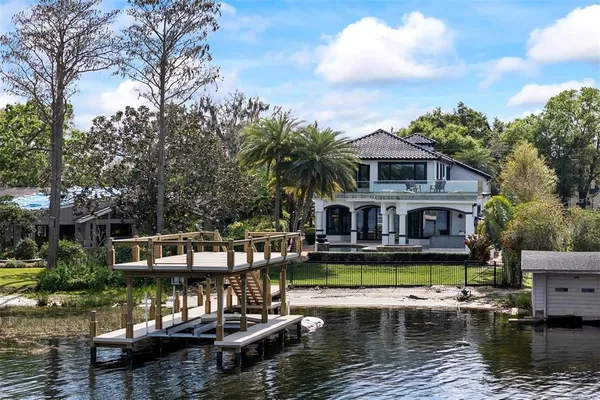 a view of house with swimming pool and outdoor seating