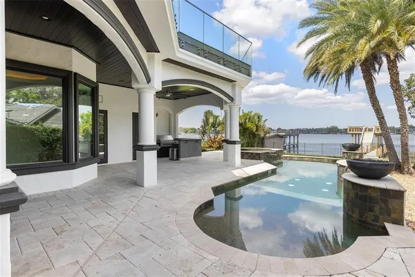 a view of a swimming pool with outdoor seating and plants